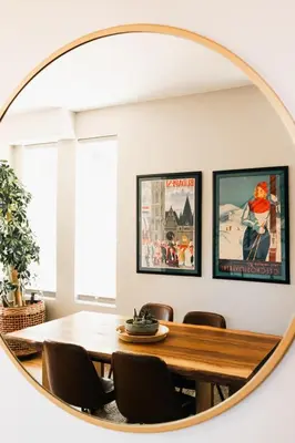 a round mirror in a dining room with a table and chairs at Modern Comfort w Mountain Views - Pet-Friendly in Denver