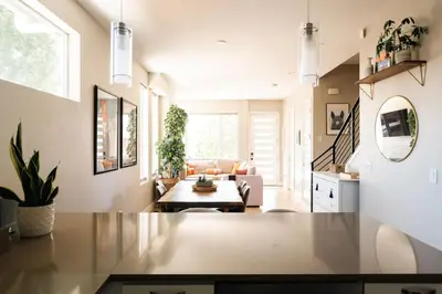 a living room with a table and a couch at Modern Comfort w Mountain Views - Pet-Friendly in Denver