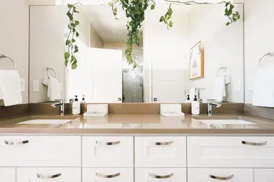 a bathroom with two sinks and a large mirror at Modern Comfort w Mountain Views - Pet-Friendly in Denver