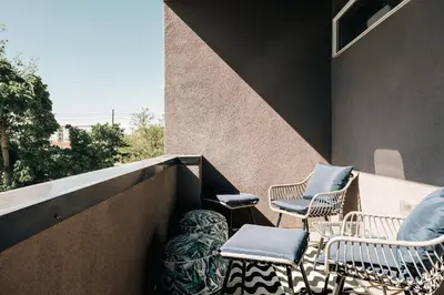 a group of chairs sitting on a balcony at Modern Comfort w Mountain Views - Pet-Friendly in Denver
