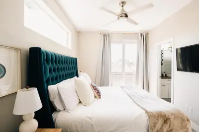 a bedroom with a large bed with a blue headboard at Modern Comfort w Mountain Views - Pet-Friendly in Denver