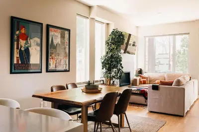 a living room with a table and a couch at Modern Comfort w Mountain Views - Pet-Friendly in Denver