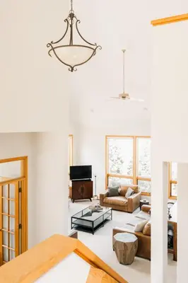 a living room with a chandelier hanging from the ceiling at Peaceful Getaway with Hot Tub - Views - Evergreen in Evergreen