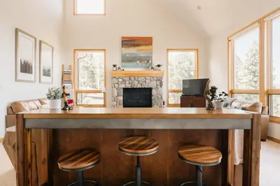 a bar in a living room with a fireplace at Peaceful Getaway with Hot Tub - Views - Evergreen in Evergreen