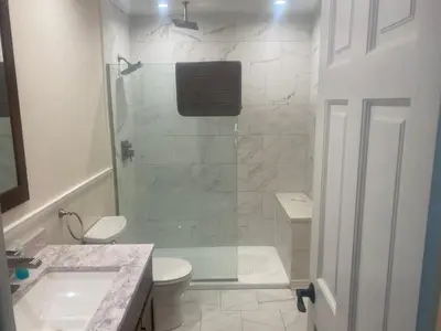 a bathroom with a shower and a toilet and a sink at Peaceful in Evergreen