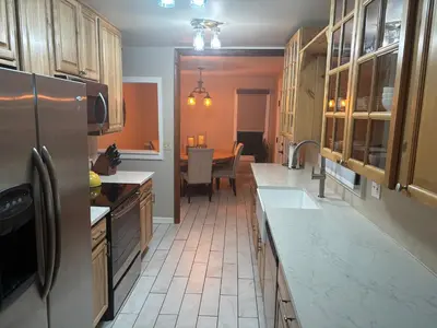 a kitchen with a refrigerator and a table in it at Peaceful in Evergreen