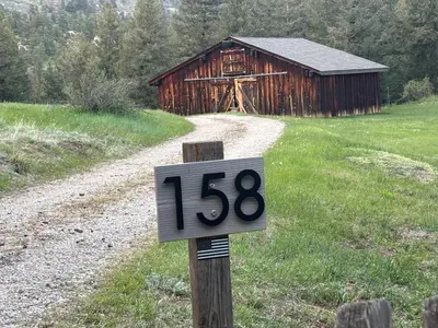 a speed limit sign in front of a barn at Peaceful in Evergreen