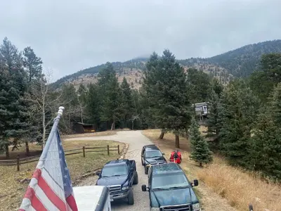 a group of cars parked on a road with an american flag at Peaceful in Evergreen