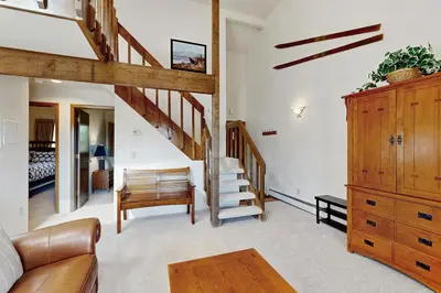 a living room with a staircase and a living room at Buffalo Ridge 305E in Silverthorne