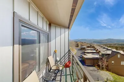 a balcony with chairs and a view of a building at Buffalo Ridge 305E in Silverthorne