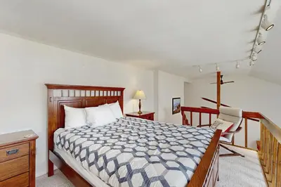 a bedroom with a bed and a desk and a chair at Buffalo Ridge 305E in Silverthorne