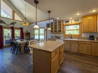 a kitchen with a table and a dining room at Columbine Cabin, 0019 in Grand Lake