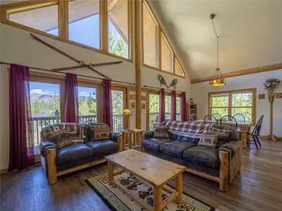 a living room with two couches and a table at Columbine Cabin, 0019 in Grand Lake