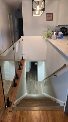 a staircase in a house with a glass railing at Alanas house in Denver