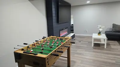 a foosball table in a living room next to a fireplace at Alanas house in Denver