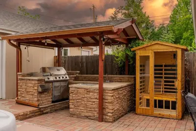 a patio with a grill and an outdoor kitchen at Movie Theatre Hot Tub Outdoor Grill in Denver