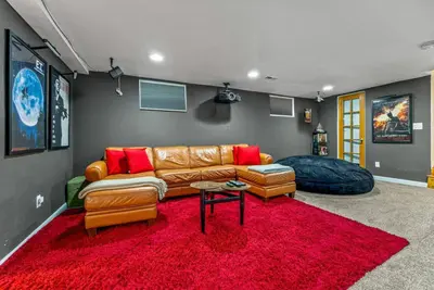 a living room with a couch and a red rug at Movie Theatre Hot Tub Outdoor Grill in Denver