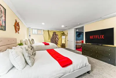a bedroom with two beds and a television at Movie Theatre Hot Tub Outdoor Grill in Denver
