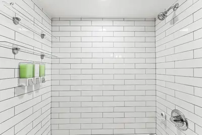 a white tiled shower with two mirrors in a bathroom at Movie Theatre Hot Tub Outdoor Grill in Denver