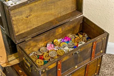 a wooden chest filled with lots of coins at Movie Theatre Hot Tub Outdoor Grill in Denver
