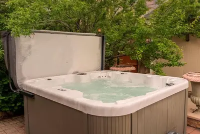 a jacuzzi tub in a yard with trees at Movie Theatre Hot Tub Outdoor Grill in Denver