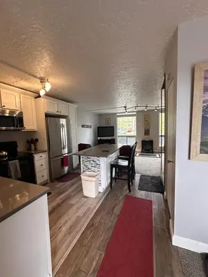 a kitchen and living room with a red rug at Dillon Valley Mountain Escape in Dillon