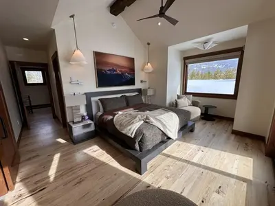 a bedroom with a bed and a large window at Serenity at Sherwood - Mid Term Rental in Breckenridge
