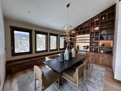 a dining room with a wooden table and chairs at Serenity at Sherwood - Mid Term Rental in Breckenridge