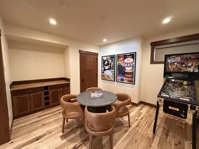 a room with a table and chairs and a video game at Serenity at Sherwood - Mid Term Rental in Breckenridge