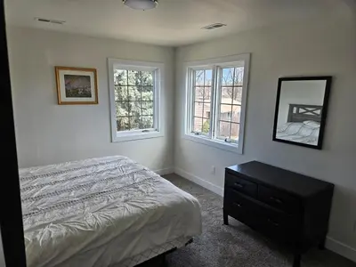 a bedroom with a bed and two windows at Sunny Beautiful Apt, 2nd Level, 2Bedroom, 2Bath, Kitchen, Dining in Denver