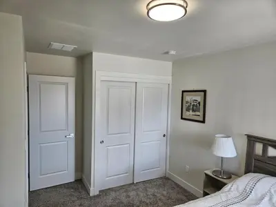 a bedroom with two white doors and a lamp at Sunny Beautiful Apt, 2nd Level, 2Bedroom, 2Bath, Kitchen, Dining in Denver