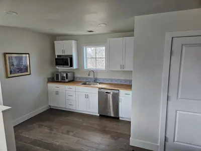 a kitchen with white cabinets and a sink at Sunny Beautiful Apt, 2nd Level, 2Bedroom, 2Bath, Kitchen, Dining in Denver