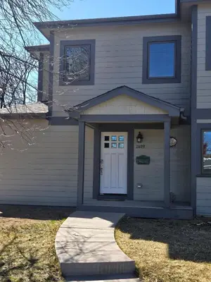 a house with a white door and a driveway at Sunny Beautiful Apt, 2nd Level, 2Bedroom, 2Bath, Kitchen, Dining in Denver