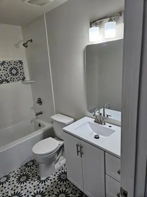 a white bathroom with a toilet and a sink at Sunny Beautiful Apt, 2nd Level, 2Bedroom, 2Bath, Kitchen, Dining in Denver