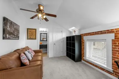 a living room with a couch and a brick fireplace at 1438 Franklin Unit 210 in Denver