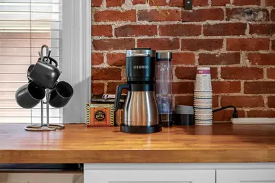 a coffee maker on a counter with a brick wall at 1438 Franklin Unit 210 in Denver