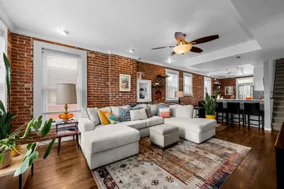 a living room with a couch and a brick wall at 1438 Franklin Unit 210 in Denver