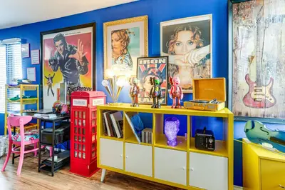 a room with a red telephone booth and posters at 8 Mi to Dtwn Denver Groovy Pet-Friendly Condo in Denver