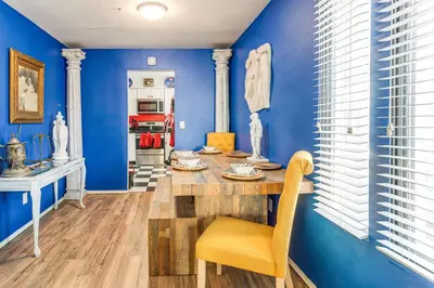 a blue room with a table and a yellow chair at 8 Mi to Dtwn Denver Groovy Pet-Friendly Condo in Denver