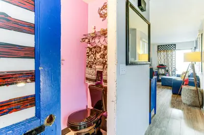 a room with a blue door and a pink wall at 8 Mi to Dtwn Denver Groovy Pet-Friendly Condo in Denver