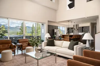 a living room with a couch and a table at Summit Solace LUXE 360 Views Hot Tub Games in Bailey