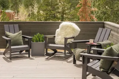 two chairs with pillows sitting on a patio at Summit Solace LUXE 360 Views Hot Tub Games in Bailey