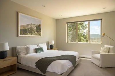 a bedroom with a bed and a couch and a window at Summit Solace LUXE 360 Views Hot Tub Games in Bailey