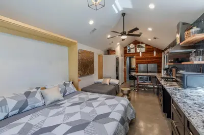 a bedroom with a bed and a living room at Modern Studio Escape in Denver in Denver