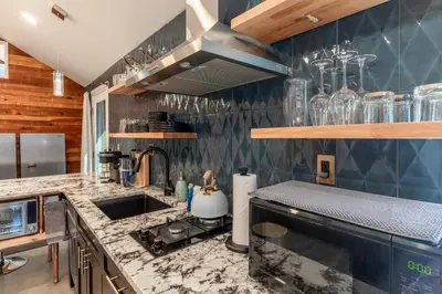a kitchen with a sink and a counter top at Modern Studio Escape in Denver in Denver