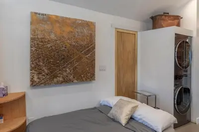 a bedroom with a bed and a painting on the wall at Modern Studio Escape in Denver in Denver