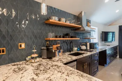 a kitchen with a marble counter top and a sink at Modern Studio Escape in Denver in Denver