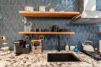 a kitchen with a sink and a counter top at Modern Studio Escape in Denver in Denver