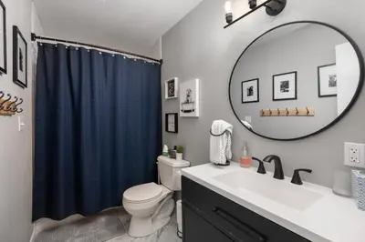 a bathroom with a sink and a toilet and a mirror at Pet Friendly, 4 Bedrooms Plus Game Room, Easy Walk to Lake Granby & Beacon Landing Marina in Grand Lake