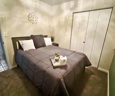 a bedroom with a large bed with a tray on it at Pet Friendly, 4 Bedrooms Plus Game Room, Easy Walk to Lake Granby & Beacon Landing Marina in Grand Lake